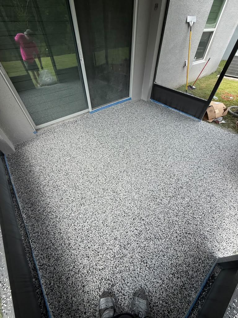 Screened patio finished with a black-and-white flake coating