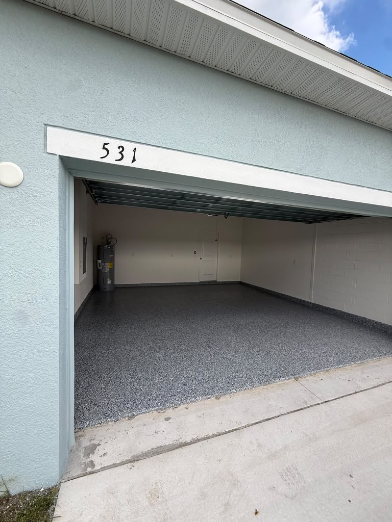Garage entrance showing completed grey flake flooring
