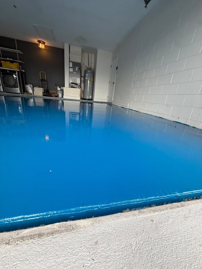 Garage floor coated in high-gloss solid blue epoxy